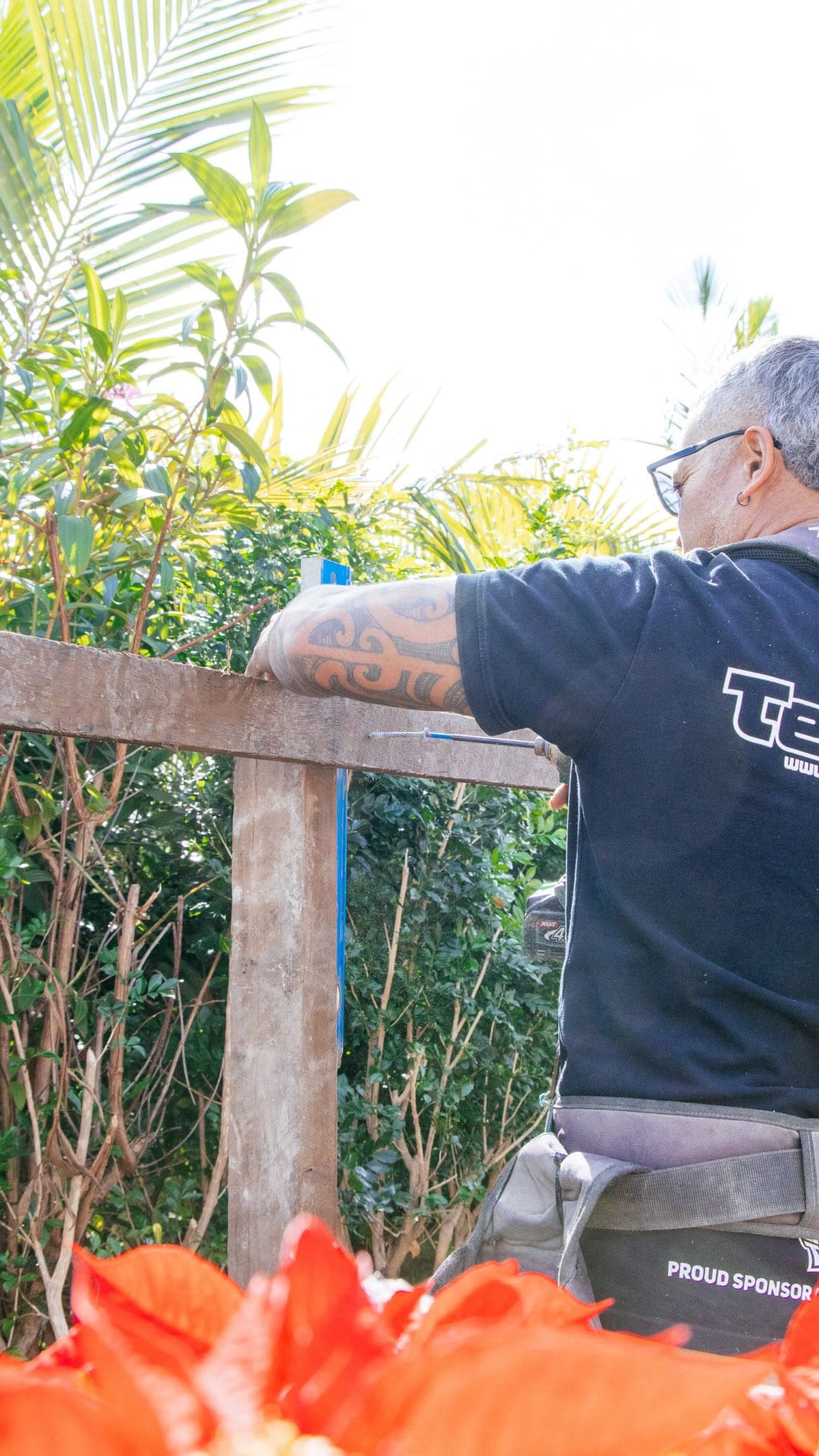 Team 247 fencer fixing a timber rail on site